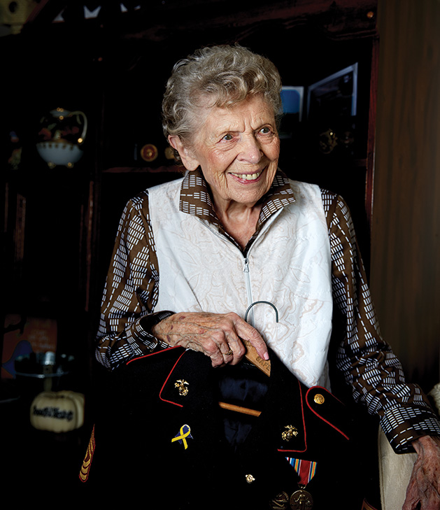June holds her uniform, which she tells us still fits. 