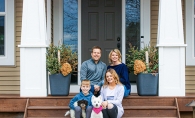 A family sits on their front steps in this photograph from the Front Steps Project