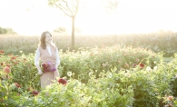 Floral designer Ashley Fox stands in a field of flowers.