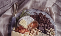 A Valentine's Day platter featuring, cheese, chocolate and other snacks.