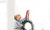 A child holds a wreath in this Focus on Woodbury photo contest winner.