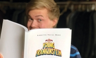 A member of Woodbury Community Theatre holds the program for "Young Frankenstein."