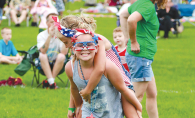 Two girls decked out in red, white and blue celebrate the Fourth of July at the Woodbury fireworks show.