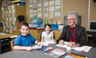 Bill Spencer leads a reading lesson with Caleb Sheehan and Sarah Kershner at Bailey Elementary School. 