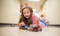 Izzy Drummond builds a Lego creation during a n e2 Young Engineers STEM class.