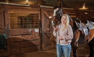 Erin Olsen poses with a horse at True North Ranch