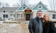 Al Shams and wife Debra stand in front of a renovated 1880 Woodbury farmhouse.