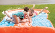 Kids playing on a slip and slide