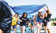 Students at Woodbury Middle School run through a makeshift tunnel to celebrate the last day of school.