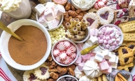 A hot chocolate board with many sweet treats.