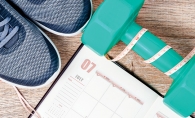 Fitness goals Exercise shoes, a free weight and a schedule tracking fitness goals.