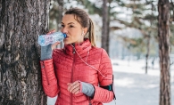 A woman drinks water to keep her hair, skin and body healthy during winter.