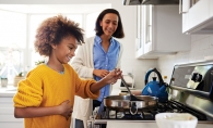 Kid helping cook in the kitchen.