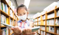 Young girl reading in a library