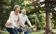 Two seniors on bikes, on their way to the East Twin Cities Boomers and Seniors Expo.