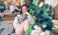 A woman reads a book on her newly remodeled patio.