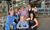 A group of women pose after working out.