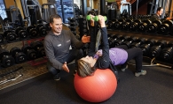Jacek Kozdroj guides a client through an exercise at Anytime Fitness in Woodbury.