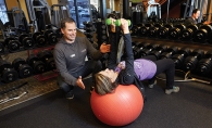 Anytime Fitness Woodbury Jacek Kozdroj guides a client through an exercise at Anytime Fitness in Woodbury.