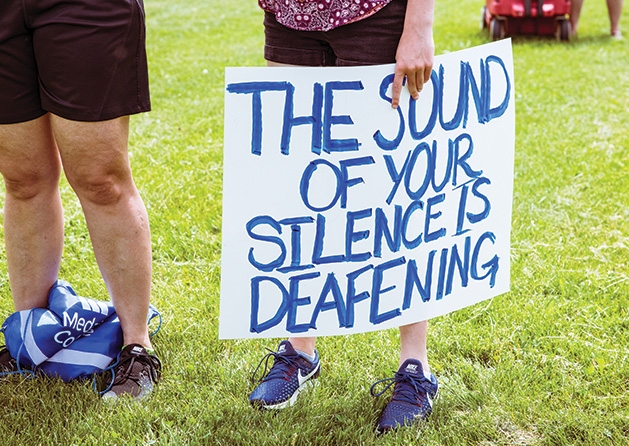 A sign that reads "The sound of your silence is deafening."
