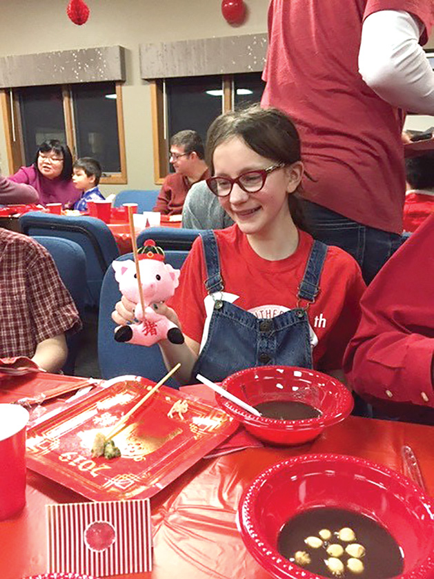 A child holds a doll at Salem Lutheran Church's Chinese New Year celebration.