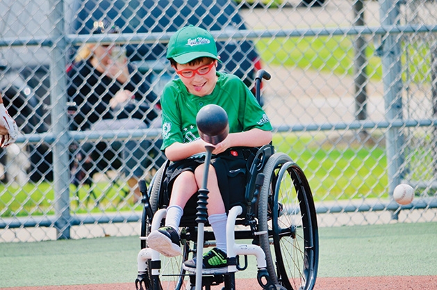 A player swings the bat at an East Metro Miracle League game