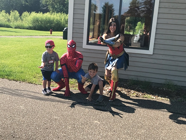 Kids pose with heroes at Woodbury Parks & Rec's Superhero Academy