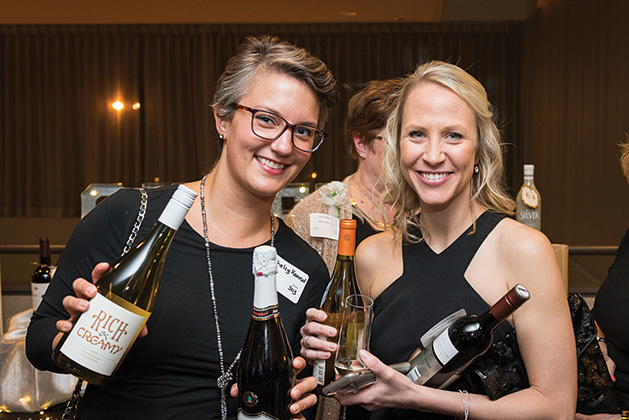 Two Woodbury Chamber Awards Gala attendees hold bottles of wine.