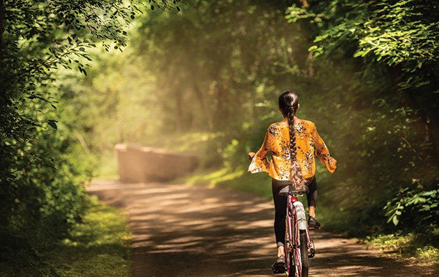 A girl biking in Carver Lake Park