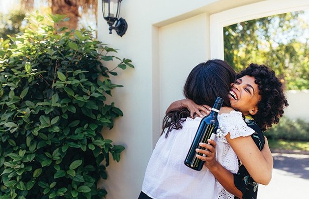 A dinner guest and host hug at the front door.