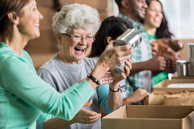 Volunteers pack food kits.