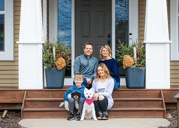 A family sits on their front steps in this photograph from the Front Steps Project