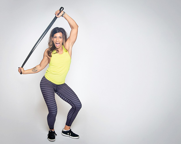 UrbanIRON Fitness owner Dena Smith works out with an exercise band.