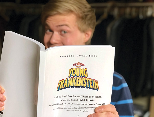 A member of Woodbury Community Theatre holds the program for "Young Frankenstein."