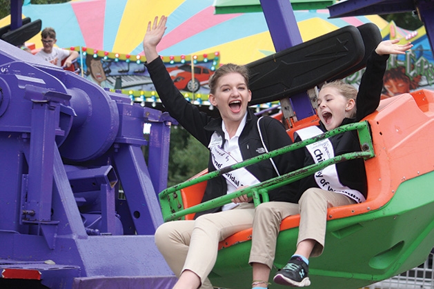 Two kids ride a ride at Woodbury Days.