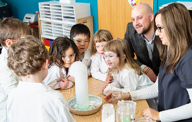 Stepping Stones Early Learning Center Stepping Stones Early Learning Center owner Aaron Nelson and teacher Bri O’Brien gather with students.