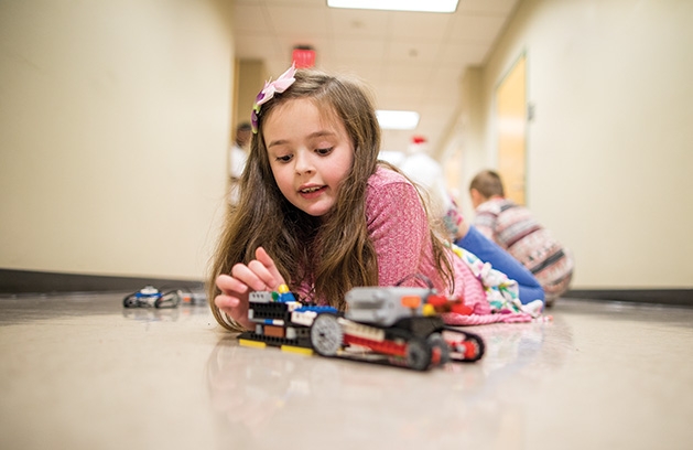 Izzy Drummond builds a Lego creation during a n e2 Young Engineers STEM class.