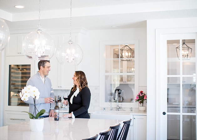 Erin and Darin Rippentrop stand in the kitchen of their Woodbury home, designed and built by Custom One Homes