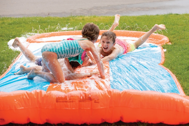 Kids playing on a slip and slide