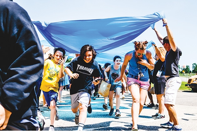 Students at Woodbury Middle School run through a makeshift tunnel to celebrate the last day of school.