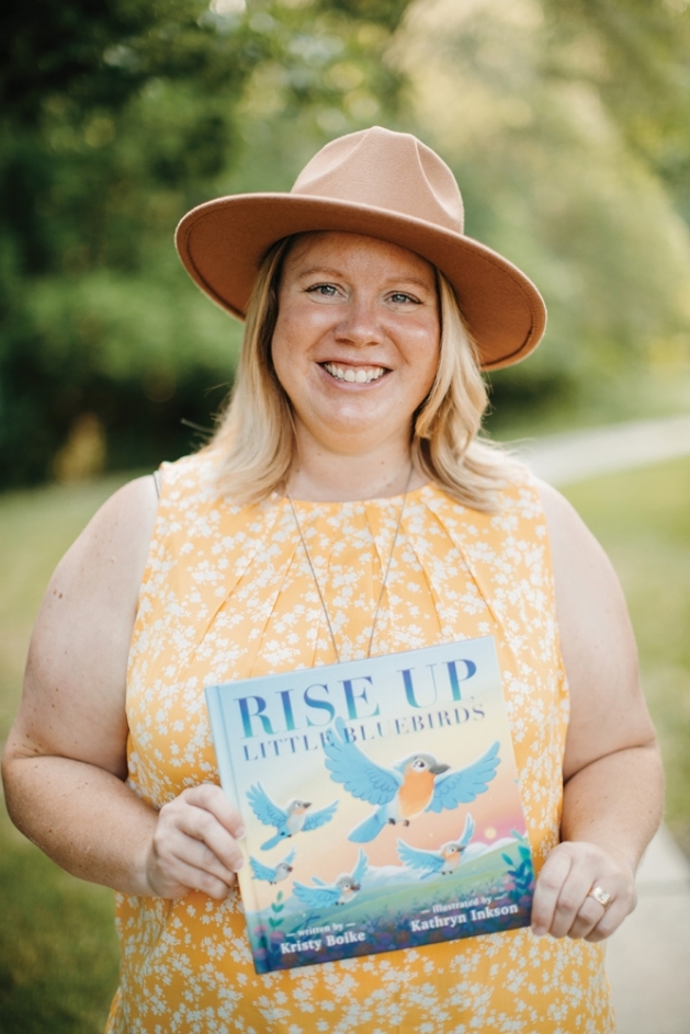 Author Kristy Boike holding her book 'Rise Up, Little Bluebirds.'