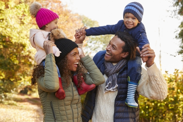 Happy family bundled up for a fall photoshoot.