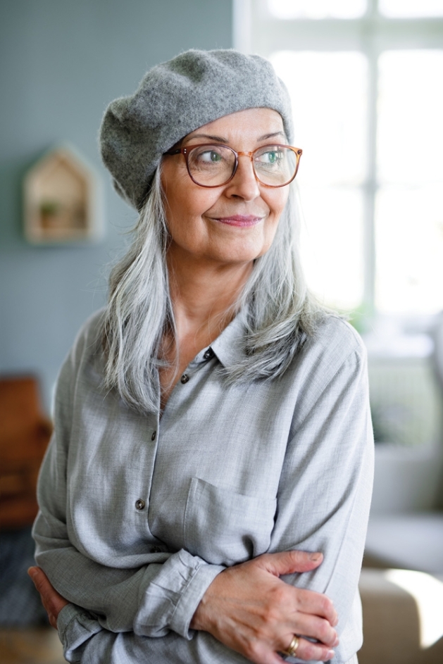 Woman with gray hair wearing gray beret.