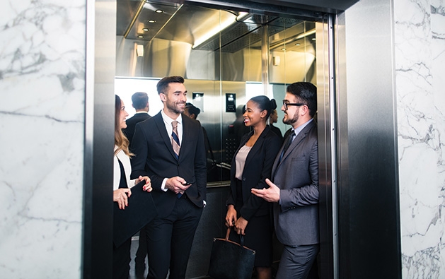 A group of people ride on an elevator.