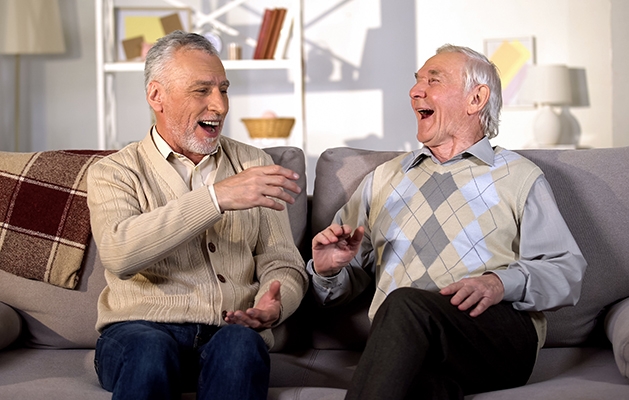 Older gentlemen laughing while having lively discussion