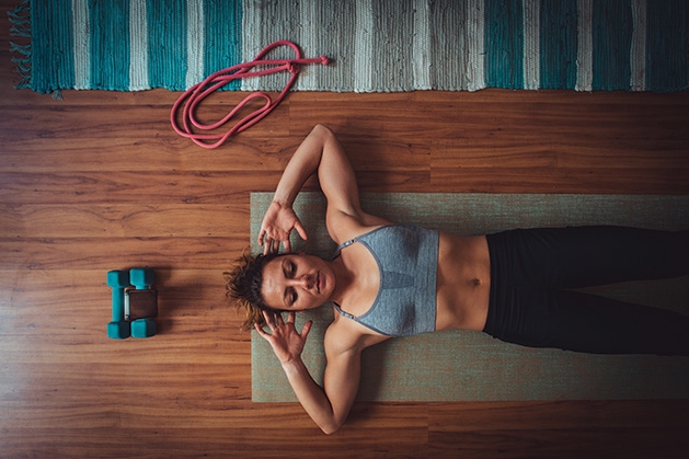 A woman works out at home.