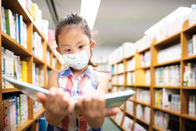 Young girl reading in a library