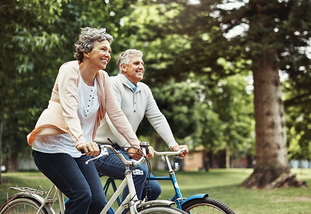 Two seniors on bikes, on their way to the East Twin Cities Boomers and Seniors Expo.