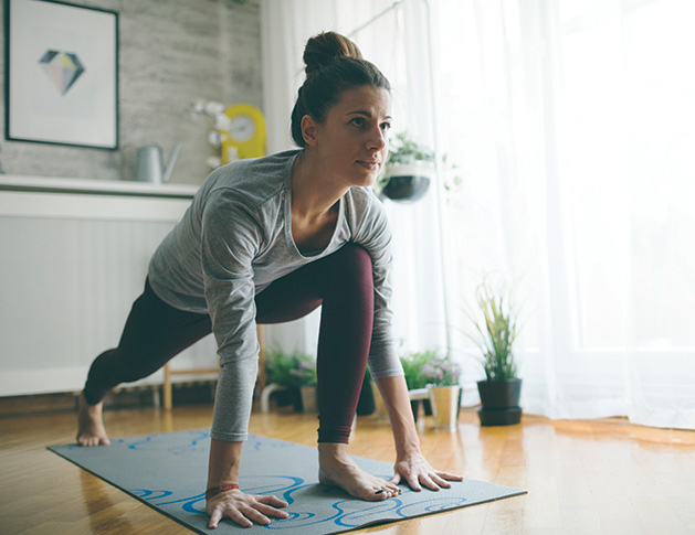 A woman does yoga as part of her fitness plan.