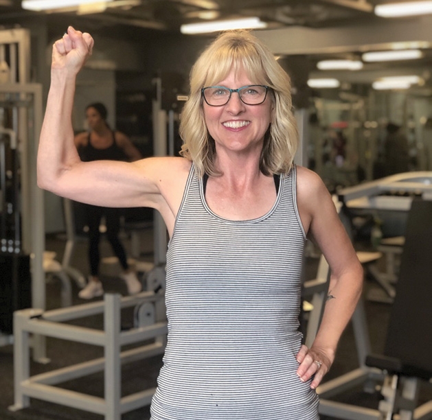 Rhonda Habel flexes at UpLift Guided Fitness in Woodbury